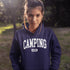 Introducing the ultimate must-have for every outdoor enthusiast who secretly wishes they could bring a slice of home comfort to the wilderness: the "Camping Mode" Hoodie.